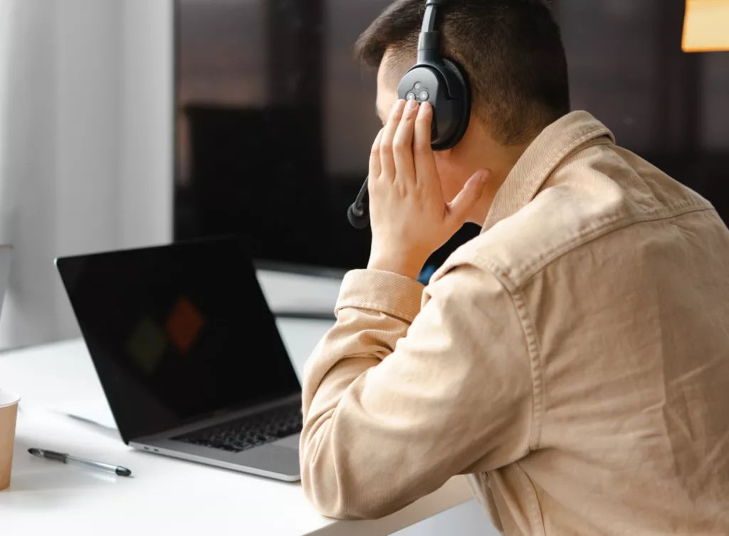 homme faisant de la transcription audio avec casque devant ordinateur